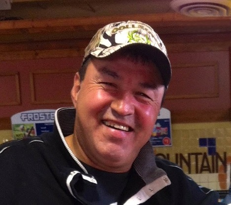 Photo of artist Richard E. Baker wearing a hat and smiling