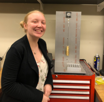 Student in front of scientific instrument