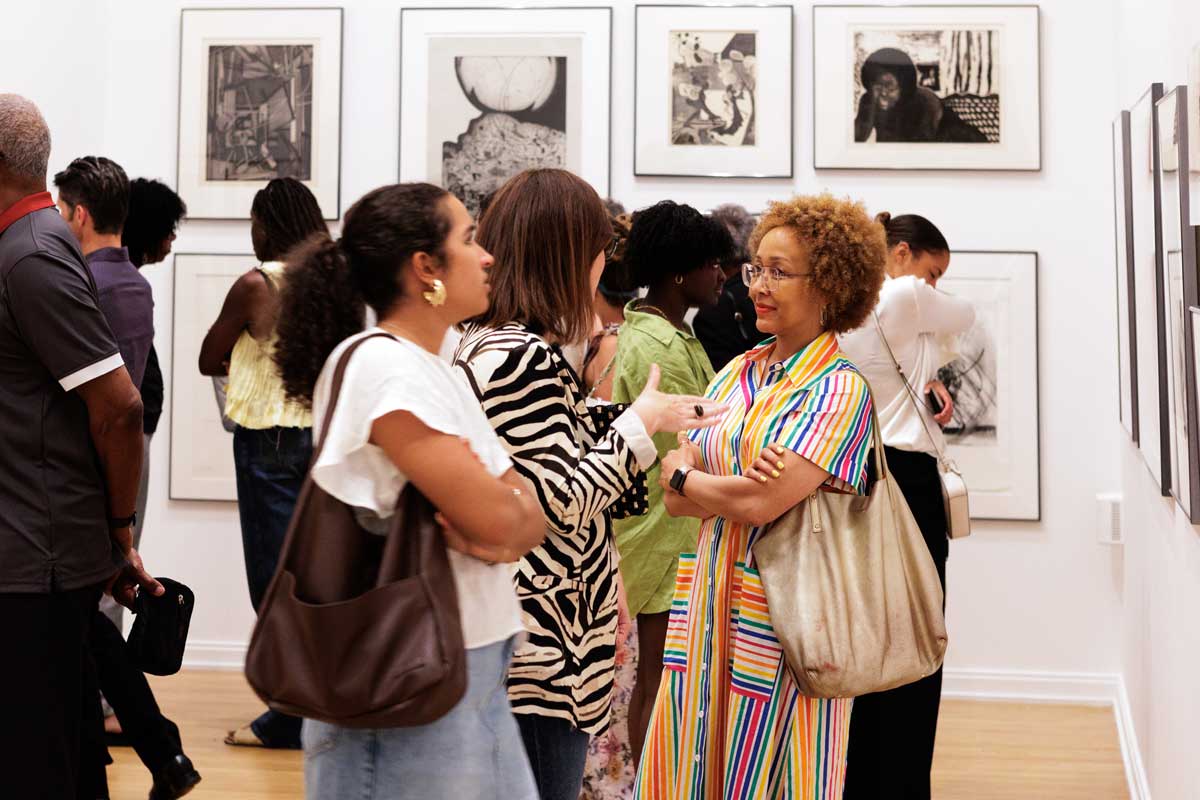 Group of people standing in the exhibition "Together: Selections from the Cochran Collection of African American Art."