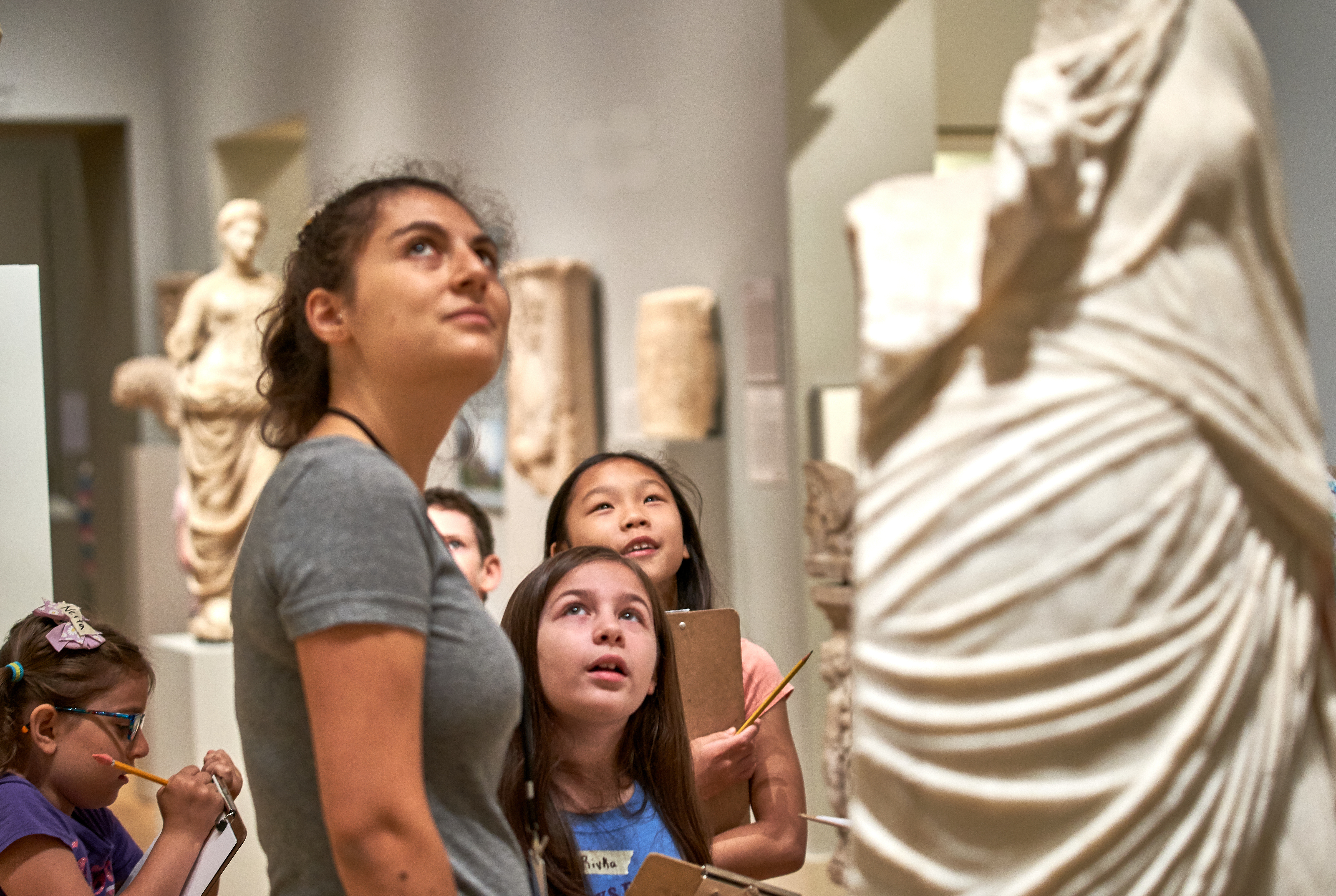 Group of people look at a sculpture in the Greek and Roman Art Galleries