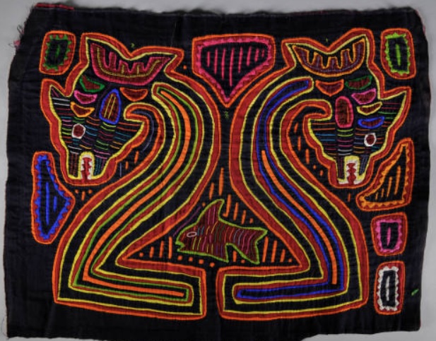 colorful Mola textile with faces of snakes on black cloth