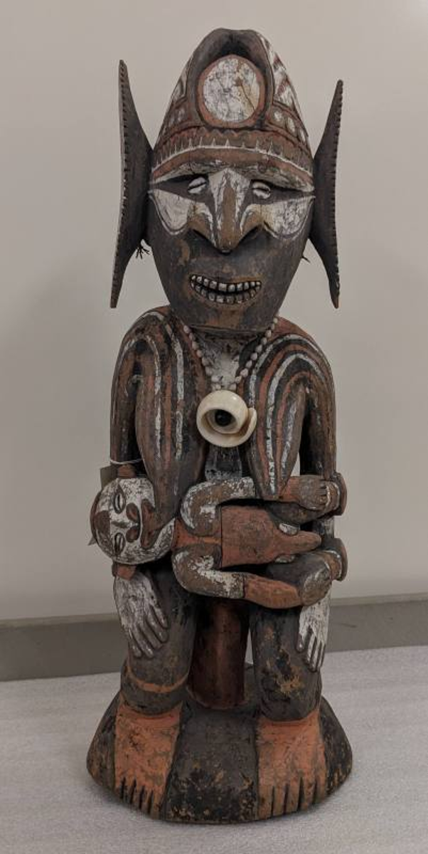 Carved wooden sculpture of a mother and child from Papua New Guinea
