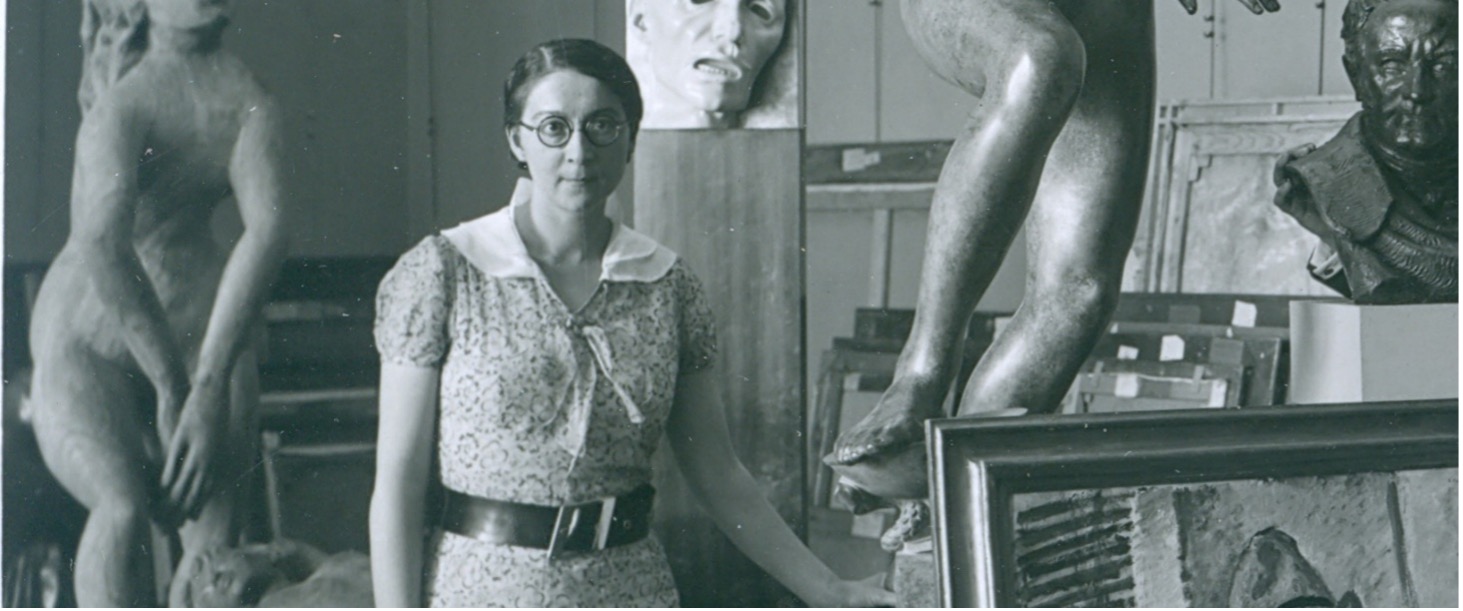 Rose Valland in the Jeu de Paume standing around sculptures and artwork