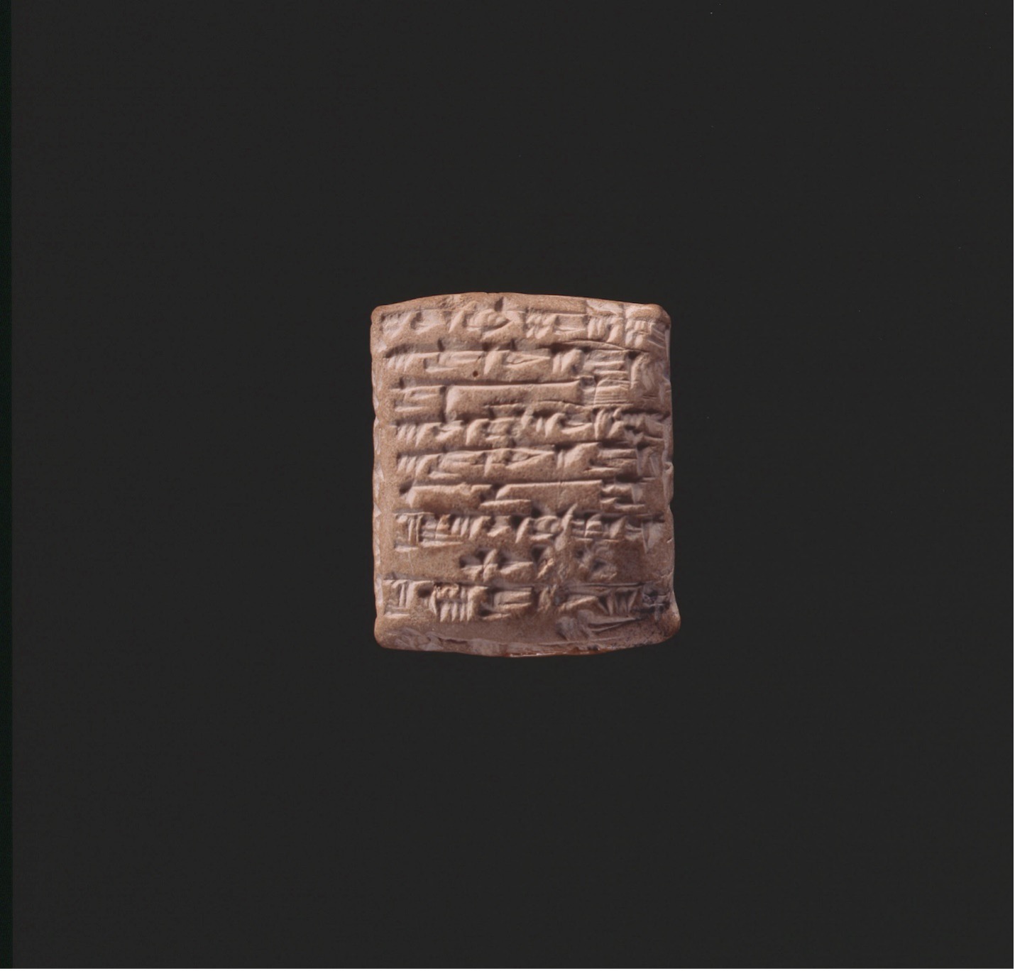 Cuneiform Tablet with Receipt of Goods to Individuals shown on a dark background