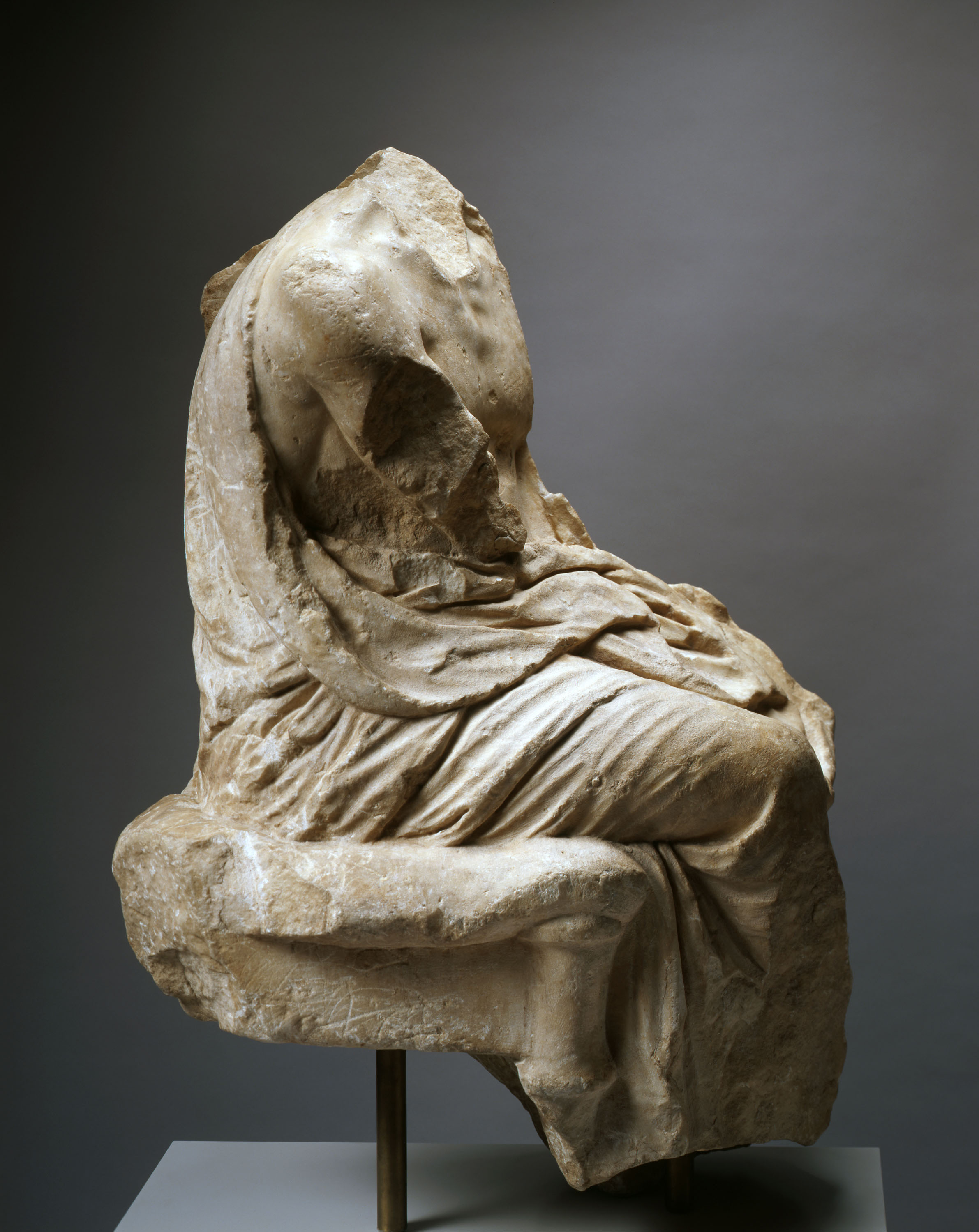 Seated Figure from a Grave Naiskos.  Greek, perhaps Attic.  Classical, ca. 350-325 BCE.  Marble.  Carlos Collection of Ancient Art.  2003.5.1.   © Bruce M. White, 2004. 