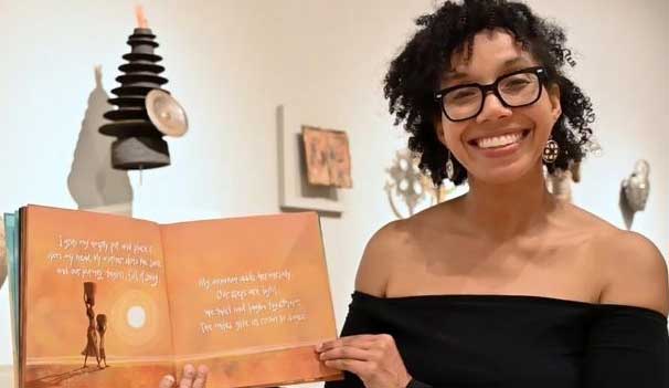 Person holding children's book open in gallery