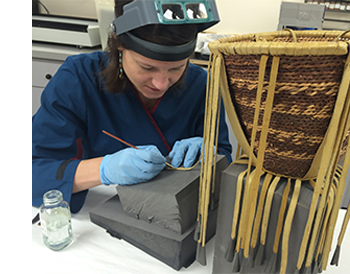 Conservator treats an Apache basket