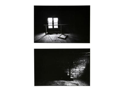 Two horizontal black and white photographs by Tom Dorsey. The photo on top is of an empty, dark upstairs room with two windows side-by-side found in the left third of the image area. There is a banister in the middle ground framing the hole in the floor for the staircase. The photo on bottom is of an empty, dark downstairs room (basement?) lined with brick and stone walls and an unfinished dirt floor. There is the dark silhouette of a flight of stairs in the middle of the image. 