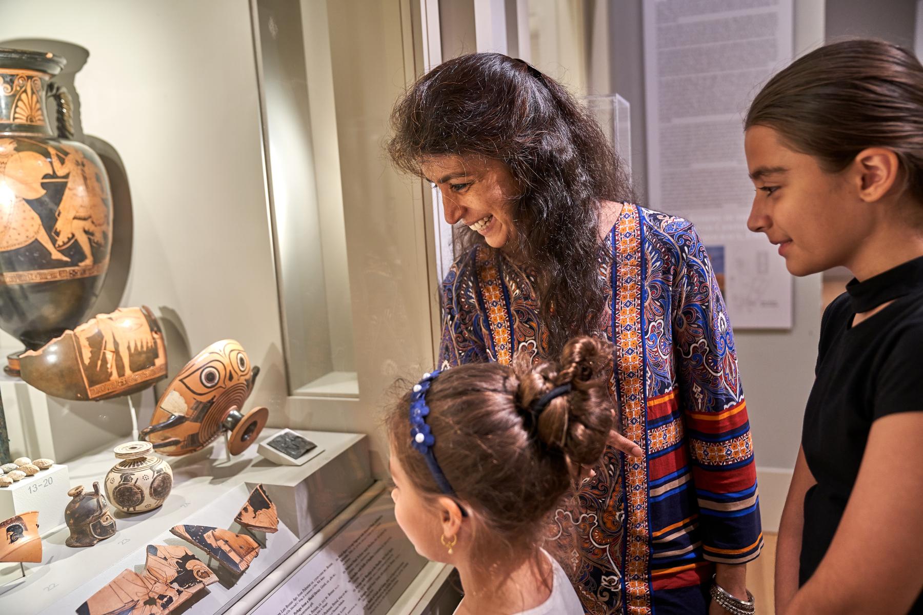 family looks at ceramic objects in the Greek and Roman art galleries