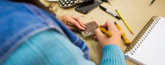 Teacher carves a wood block