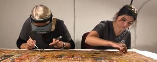 Conservators work on the Cosmic Man